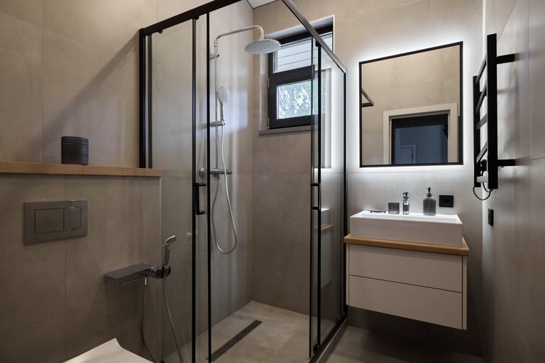Luxurious bathroom renovation with glass shower enclosure and modern fixtures