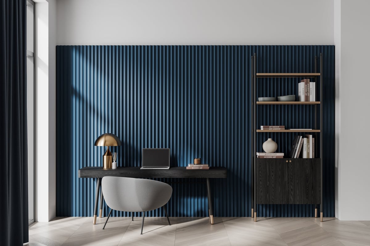 Contemporary home office with a sleek wooden desk, grey armchair and natural materials