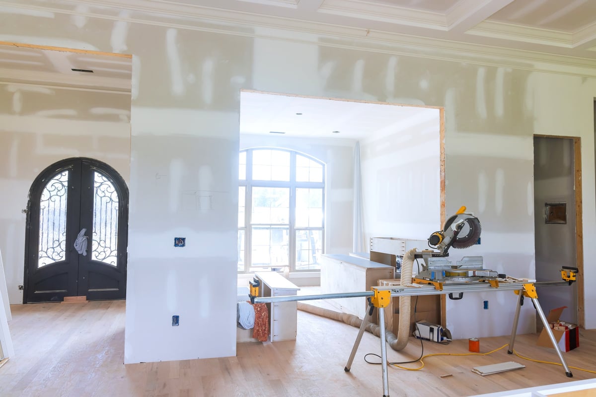 Home interior renovation with tools and unfinished walls