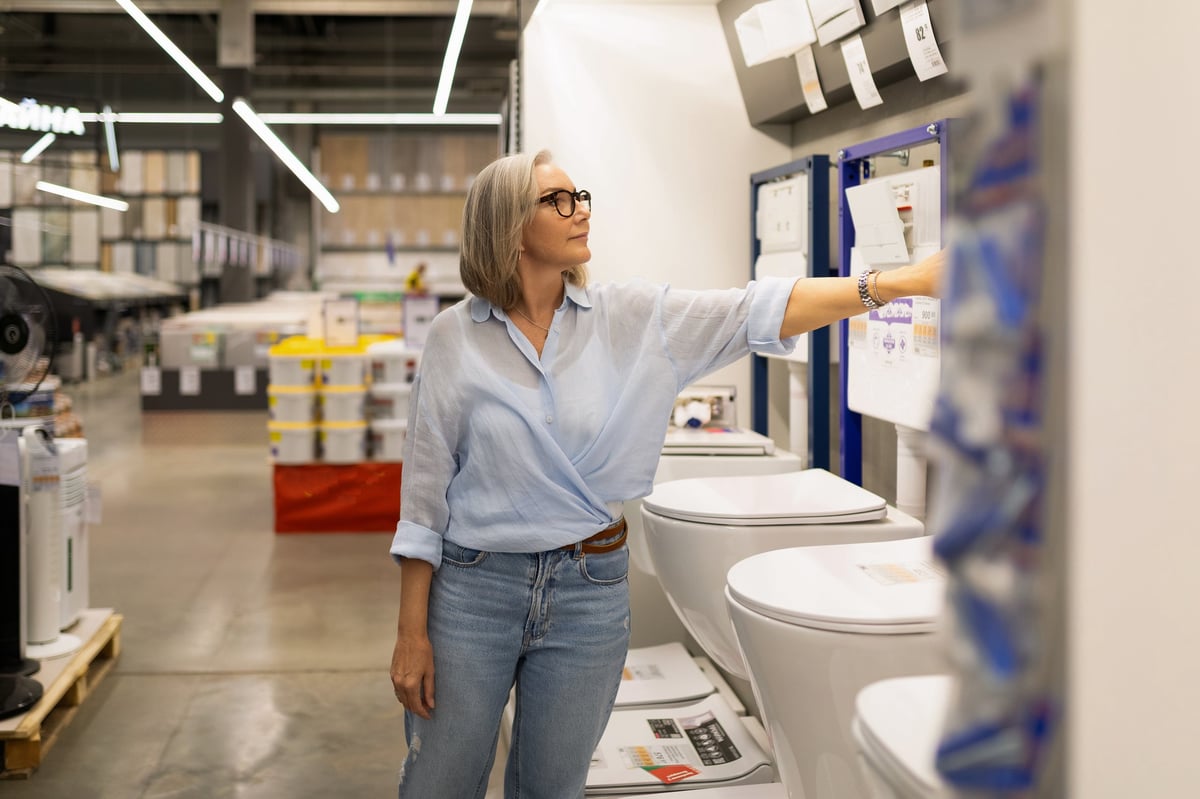 Homeowner selecting bathroom fixtures and materials for a renovation project