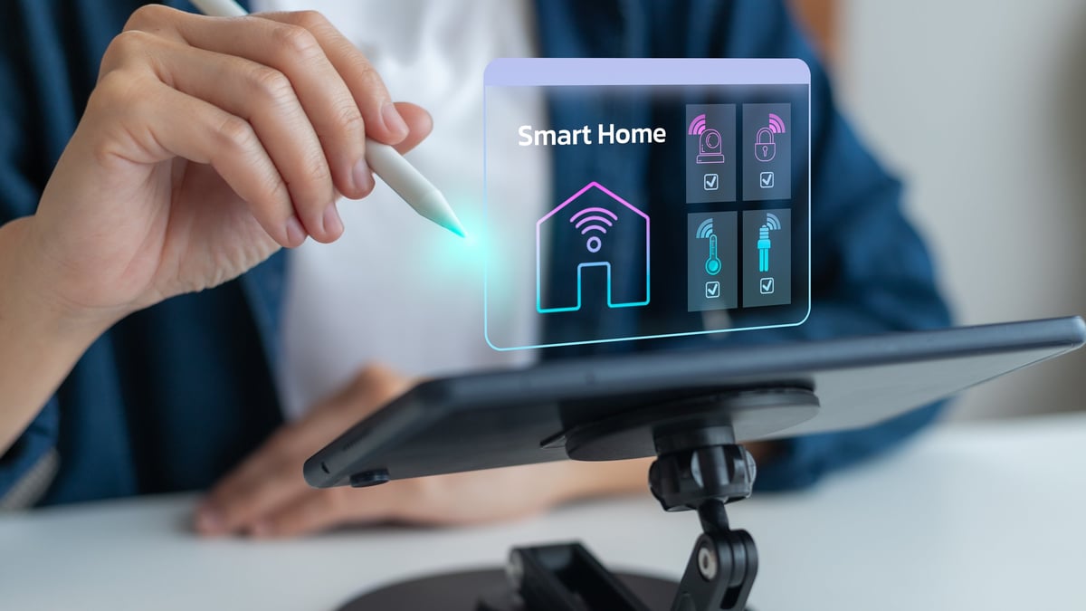 Person using tablet with smart home automation hologram, IoT and home energy management