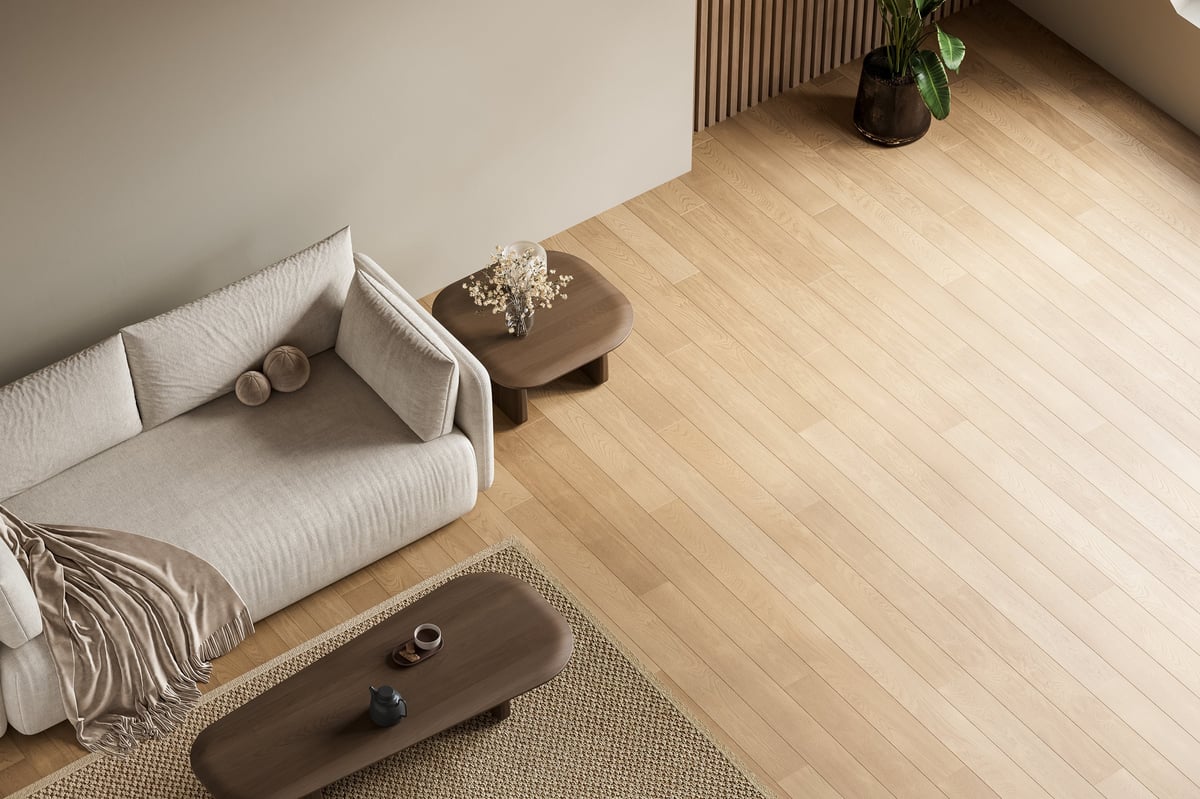 Top view of modern minimalist living room with beige sofa and light oak hardwood flooring in soft natural light