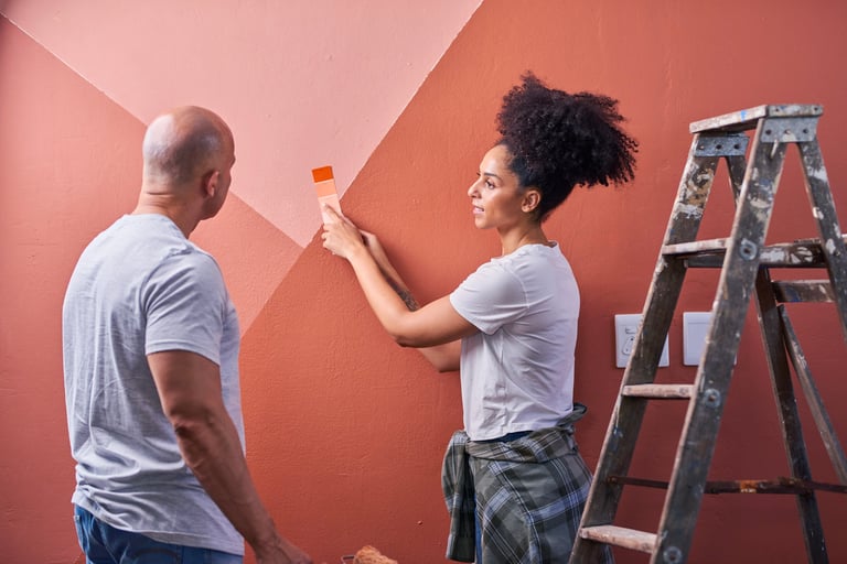 Professional preparation and painting work in progress on a home interior wall
