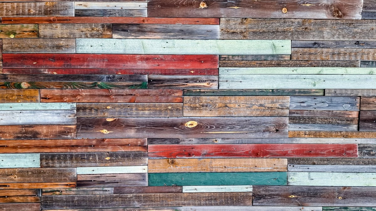 Weathered rustic wooden planks in warm earthy tones used as a sustainable design texture