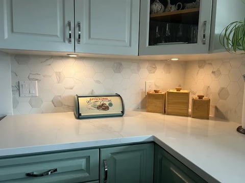 Chilliwack kitchen renovation featuring modern design, white countertops, hexagonal tile backsplash, teal cabinets and custom wooden accents